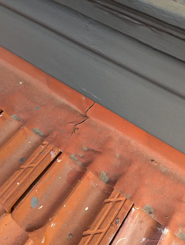 Damaged roof flashing around chimney, a common leak source