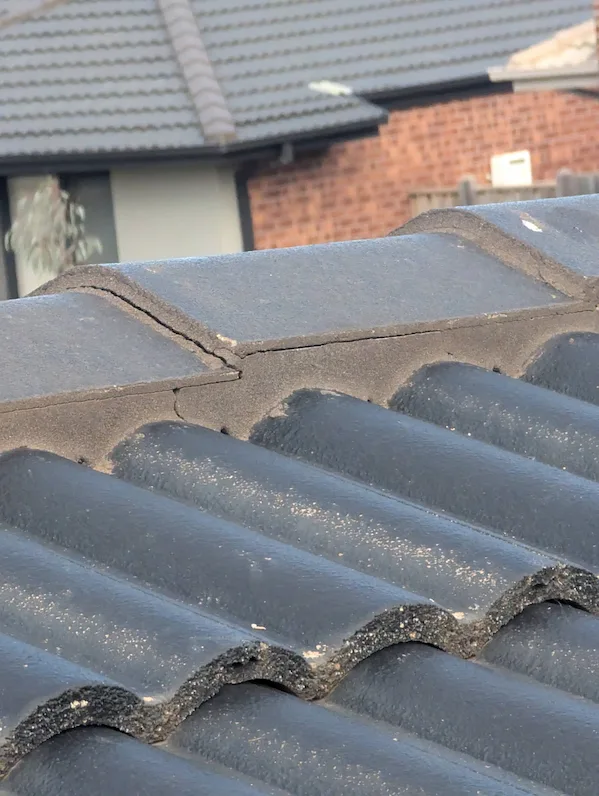 Roof with cracked and missing mortar before repointing